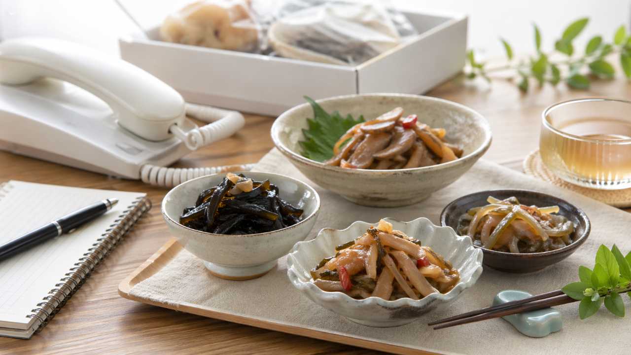 北海道函館の海産加工品を連想させる落ち着いた作業場と食卓の雰囲気、昆布佃煮や松前漬けを思わせる小鉢