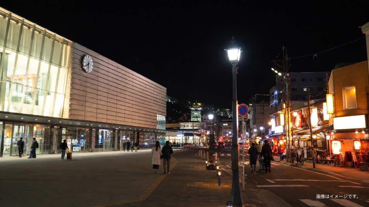 函館駅前の夜、居酒屋の看板と歩く旅行者